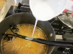 someone is pouring milk into a pan on the stove