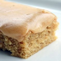 a piece of cake with frosting sitting on a plate