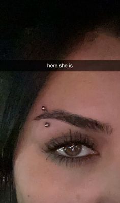 a woman with piercings on her nose and eyebrows