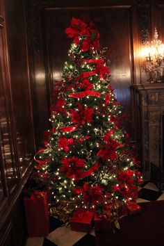 a christmas tree with red bows and lights