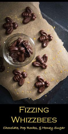 a glass bowl filled with chocolate covered pretzels on top of a piece of parchment paper