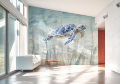 a room with a large wall mural depicting a sea turtle