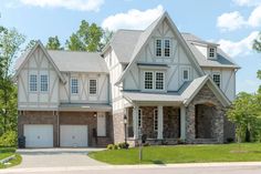 a large white and brown house with lots of windows