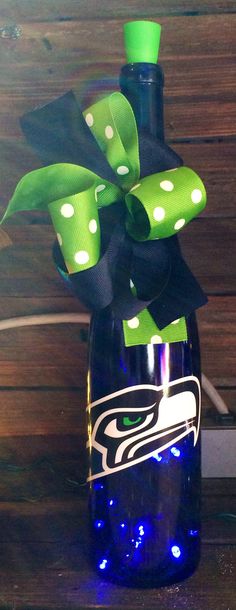 a green and black bow on a seattle football bottle