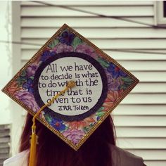 a woman wearing a graduation cap with a quote on it