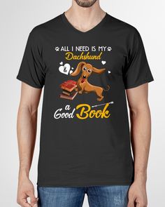 a man wearing a black t - shirt that says, all i need is my dachshund and a good book