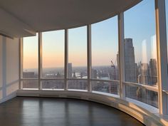 an empty room with large windows overlooking the city