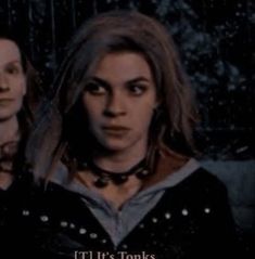 two women standing next to each other in front of a dark background with the words it's tonks