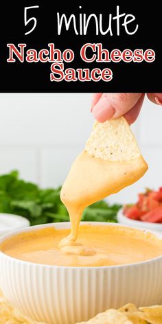 nacho cheese sauce in a white bowl with tortilla chips on the side