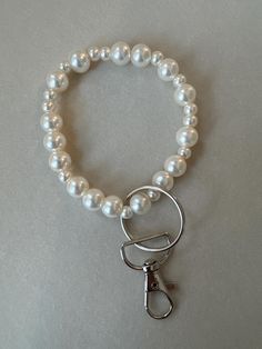 a white pearl bracelet with a metal clasp