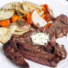 steak, potatoes and carrots on a white plate