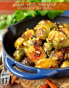 brussel sprouts in a blue skillet on top of a wooden table