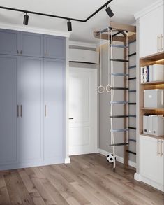 an empty room with wooden floors and shelves