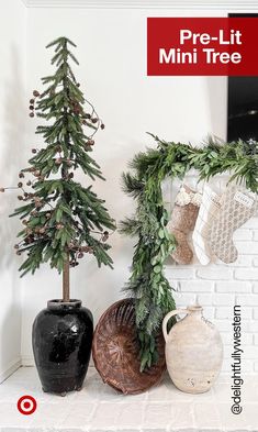 christmas decorations are displayed in front of a white brick wall with red lettering that reads pre - lit mini tree