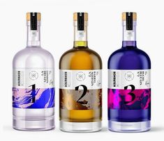 three bottles of alcohol sitting next to each other on a white surface with the number thirteen printed on it