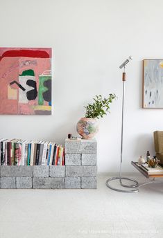 a bookshelf made out of cinder blocks in the corner of a living room