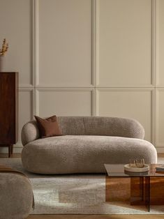 a couch and table in a room with white walls