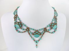 a necklace with turquoise beads on a mannequin