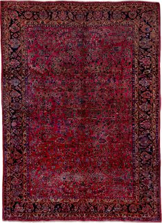 an antique rug with red and blue colors