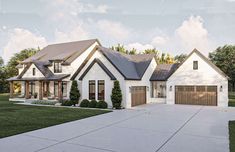 a white house with two garages in the front yard