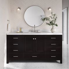 a bathroom with two sinks and a large round mirror above the sink, along with vases