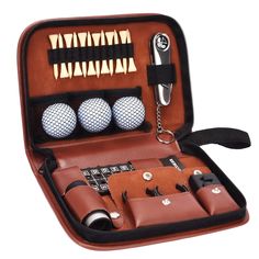 an open leather case with golf balls and accessories in it on a white background,