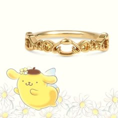 a gold ring with an image of a cartoon character on the front and side, surrounded by daisies