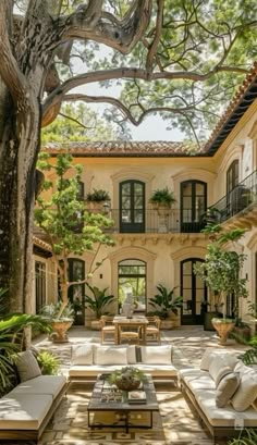 an outdoor living area with couches and tables