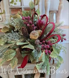 a vase filled with lots of different types of flowers and greenery on top of a table