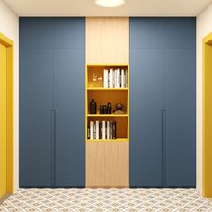 an empty room with bookshelves and cabinets on the wall, next to a tiled floor