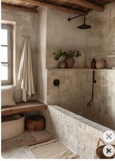 a bath room with a toilet and a shower head mounted to the side of a wall