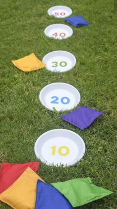 the number ten is placed in front of several colorful kites on the green grass