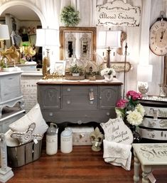 a room filled with lots of different types of furniture and decor on top of a hard wood floor