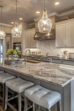 a large kitchen with marble counter tops and stools