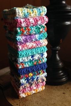 a stack of crocheted dishcloths sitting on top of a table