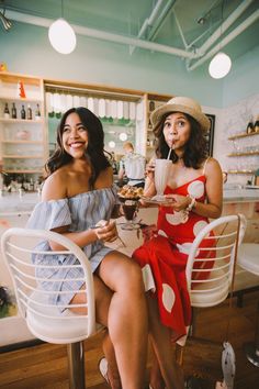 two women sitting at a table eating food