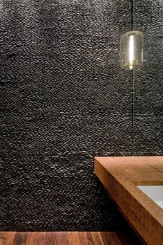 a bathroom with a wooden counter top next to a white sink