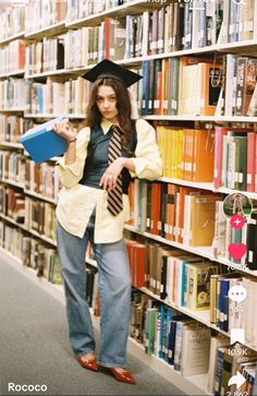 a woman standing in front of a bookshelf holding a blue folder and wearing a hat