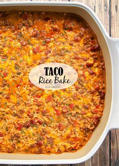 taco rice bake in a white casserole dish on a wooden table