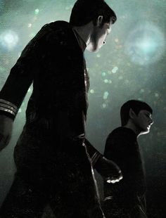 two people standing next to each other in front of a dark background with lights and stars