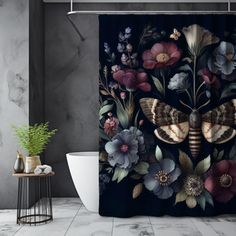 a bathroom with a shower curtain decorated with flowers and butterflies on it, along with a plant in the corner