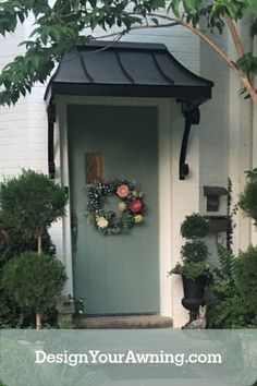 a front door with a wreath on it and the words design your awning com