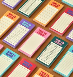 several colorful notebooks with different times to check them on top of each other, all lined up in rows