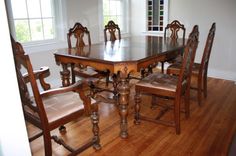 a dining room table and chairs in front of a window