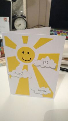 a yellow and white greeting card with the words get well written in front of it