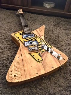 a guitar made out of wooden planks on the floor