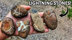 a hand holding five rocks with different designs on them and the words lightning stones above it