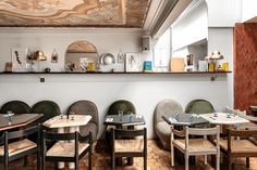 the interior of a restaurant with tables and chairs