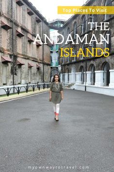 a woman walking down an empty street in the middle of some buildings with text overlay that reads top places to visit the andaman islands