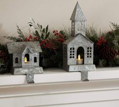 two small houses are sitting on the mantle